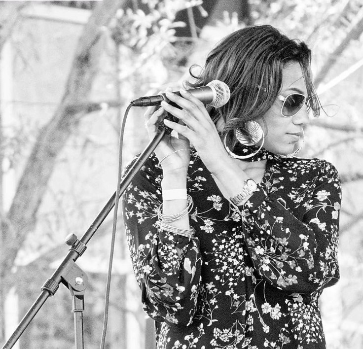 Mia Stokes performing live with a microphone
