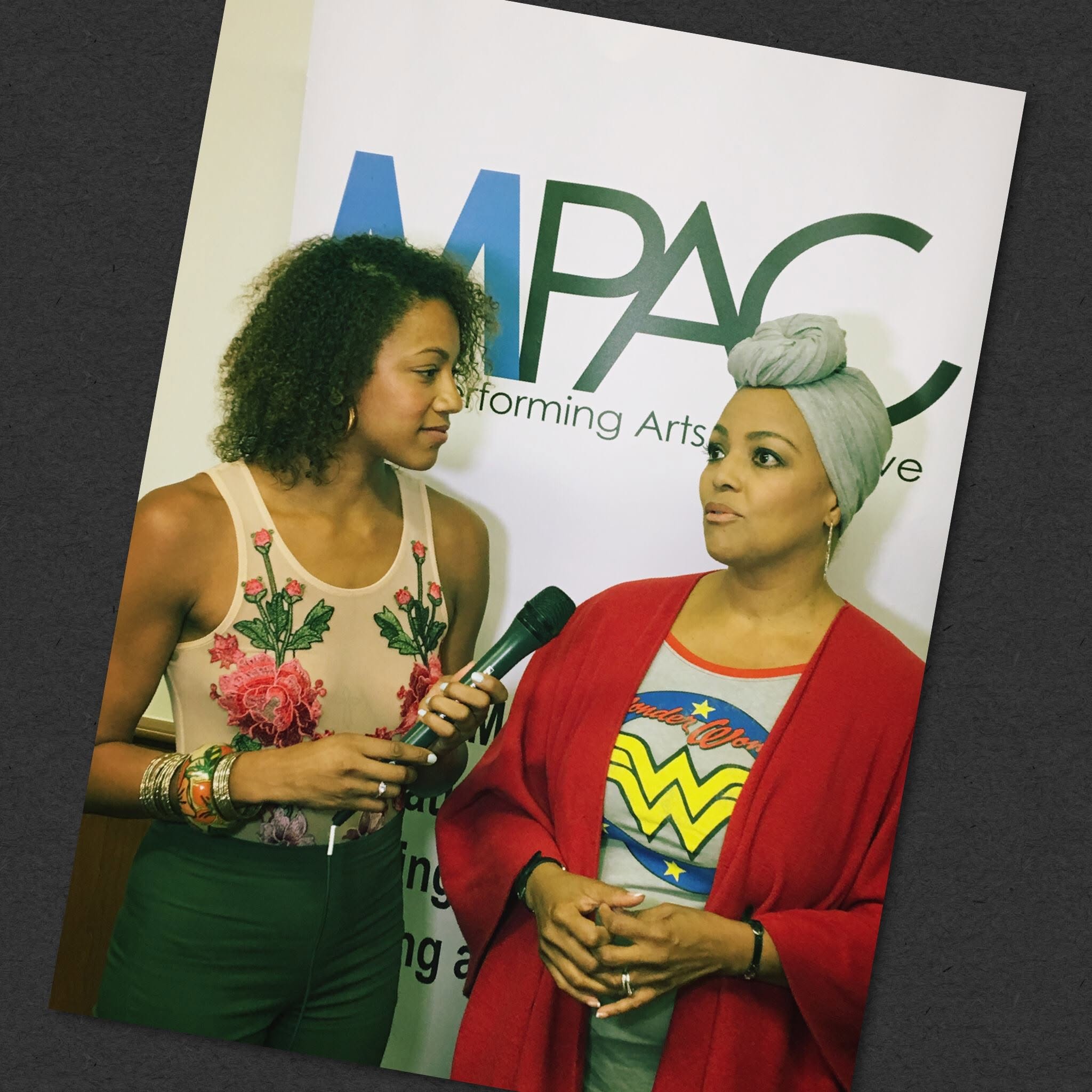 Mia Stokes interviewing Kim Fields while covering an MPAC event